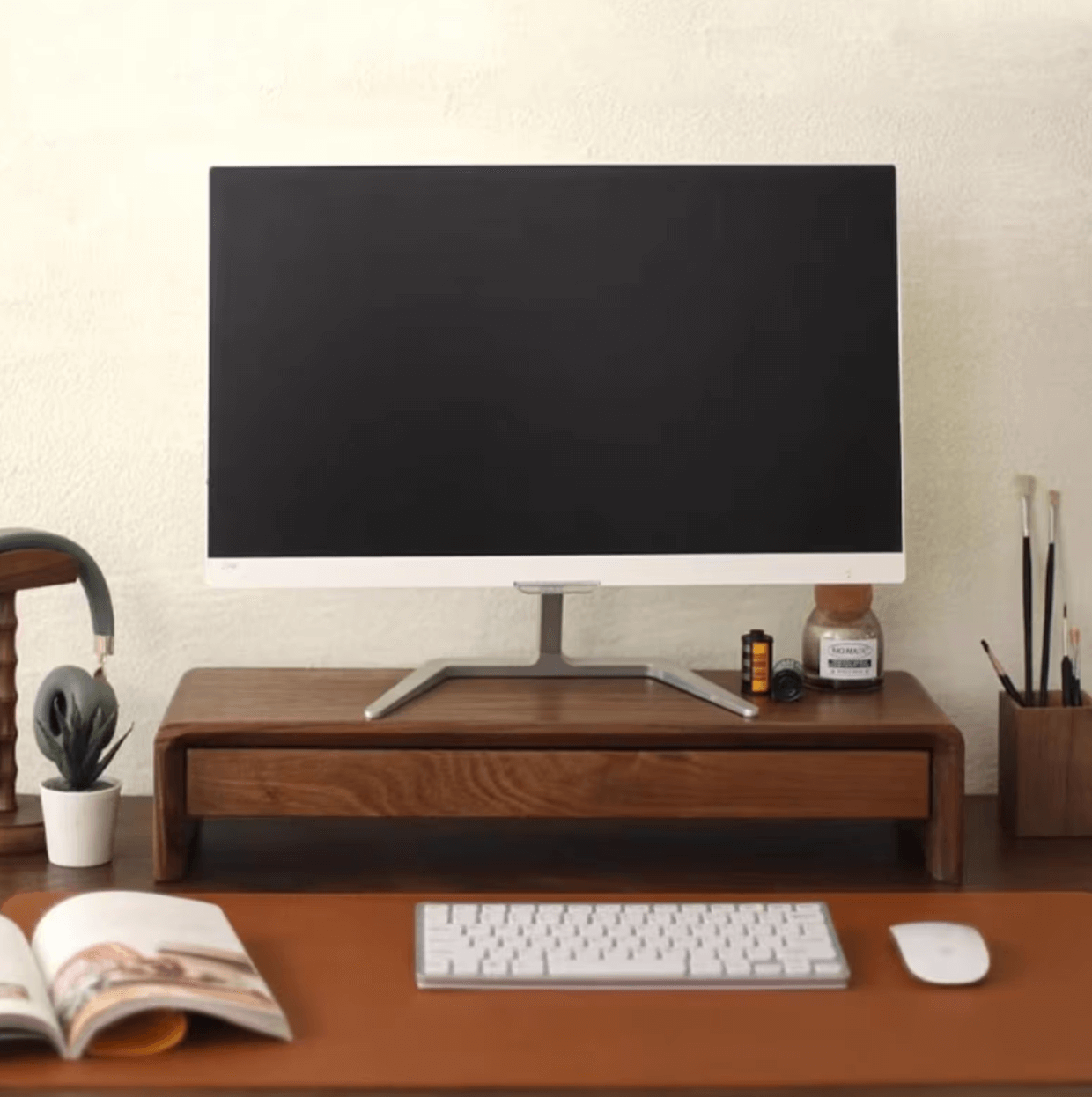 Monitor on a Desktop stand with keyboard and mouse on a desk