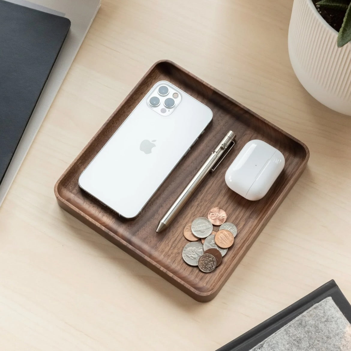 Wooden tray with phone, pen, and earbuds on a light wooden surface, medium sized desk trays, catchall tray, organizer trays,
