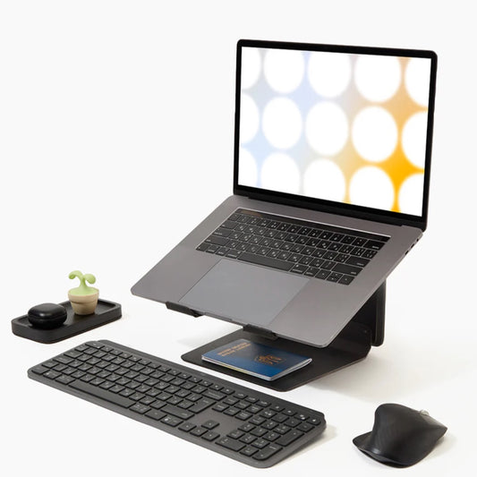 Laptop on a laptop stand with keyboard, mouse, and small plant on a white background, ergonomic laptop stand, tower laptop stand,